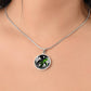 Woman wearing an Elegant silver pendant featuring a vivid Green Turtle Necklace with a moon, Stars, Clouds and Ocean set against a black  backdrop. This jewelry offers personalization with an engraving option for a name.