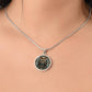 Woman wearing an elegant silver pendant featuring a Celtic Owl Necklace, set against a Green and orange backdrop. This jewelry offers personalization with an engraving option for a name.