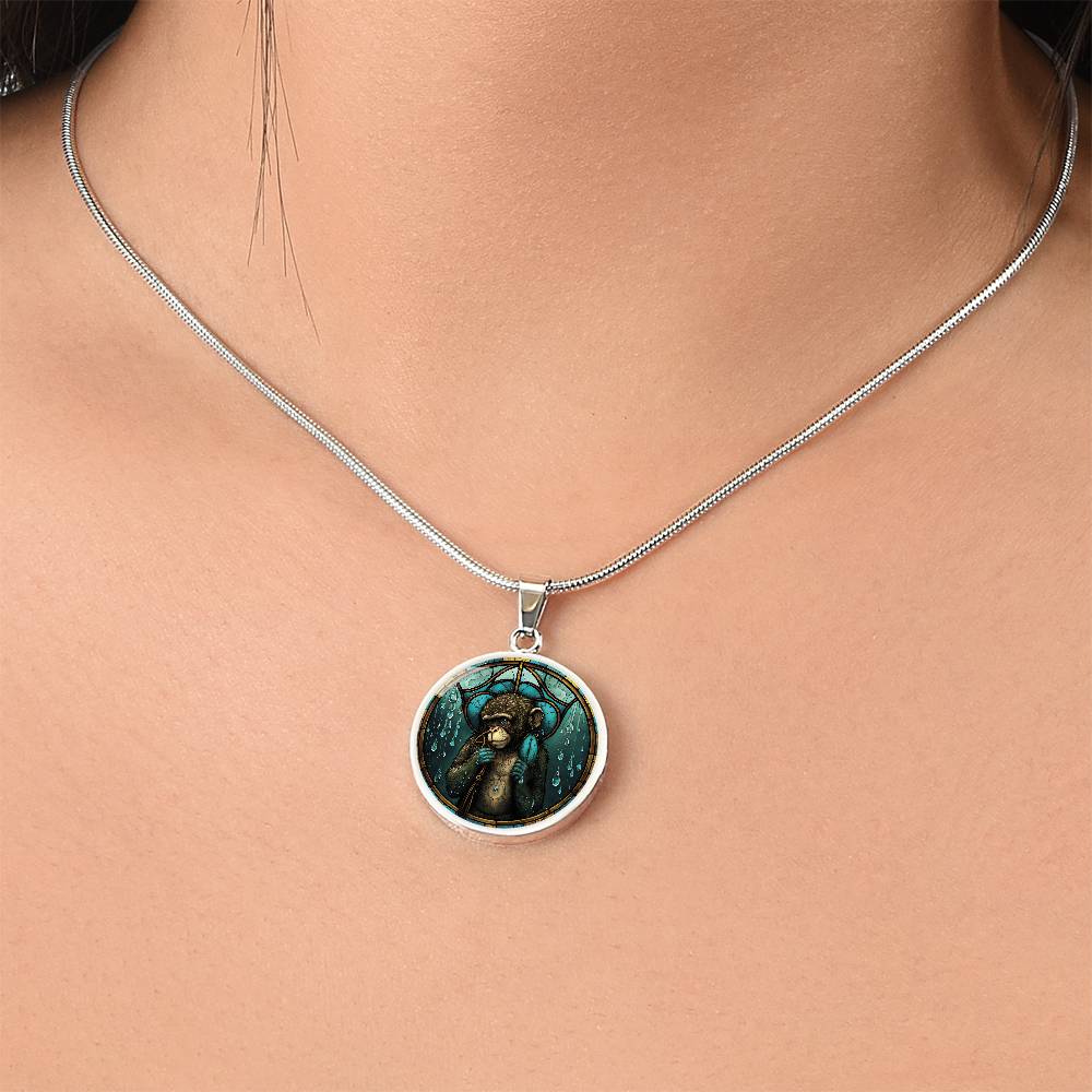 Woman wearing an elegant silver pendant Chinese Zodiac Monkey Necklace. The colors are yellow, blue, teal, brown and green. This jewelry offers personalization with an engraving option for a name.