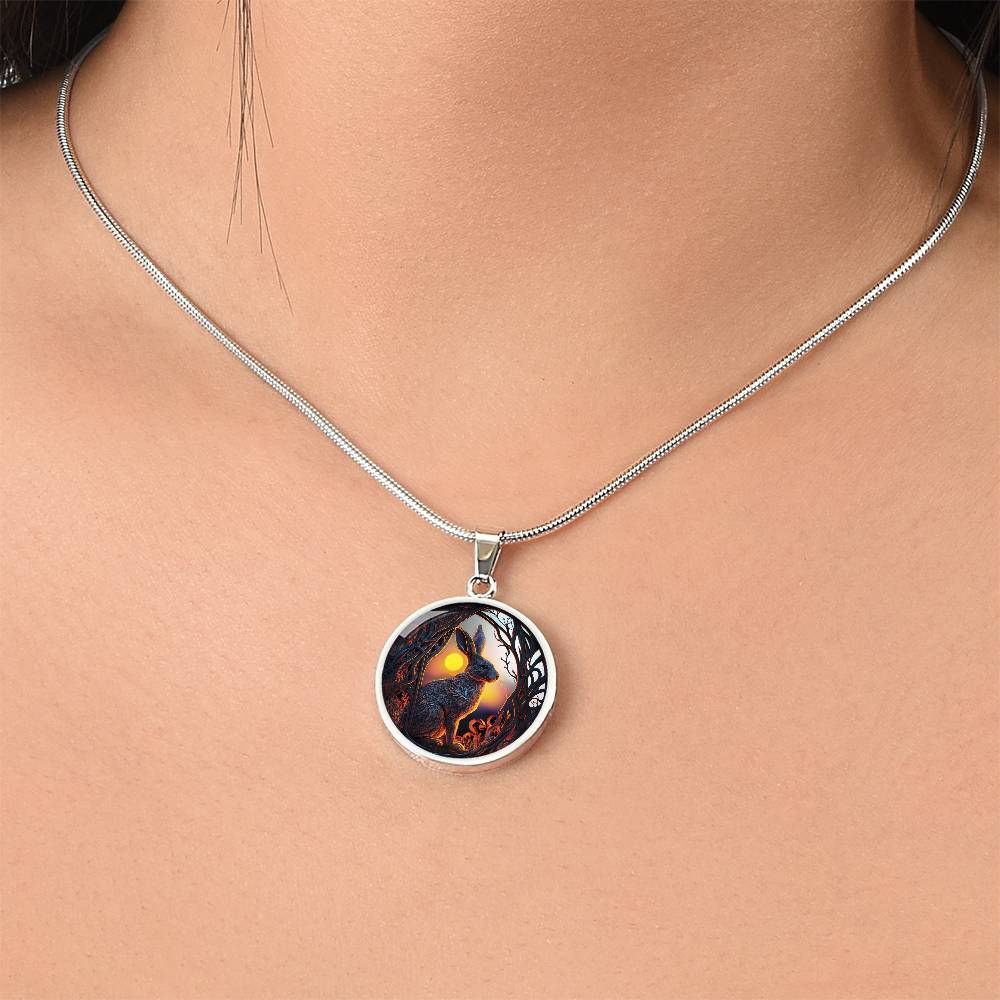 Woman wearing an Elegant silver pendant Easter Bunny necklace featuring yellow sun, brown trees, brown rabbit, blue and white sky. This jewelry offers personalization with an engraving option for a name.