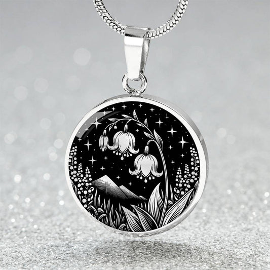 An Elegant silver pendant Lily Of The Valley Necklace featuring Mountains, Stars, Grass, Lily Of The Valleys all in black and silver. This jewelry offers personalization with an engraving option for a name.