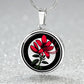 Elegant silver pendant featuring a vivid red honeysuckle, Junes birth month flower, set against a subtle tan backdrop. This necklace offers personalization with an engraving option for a name.