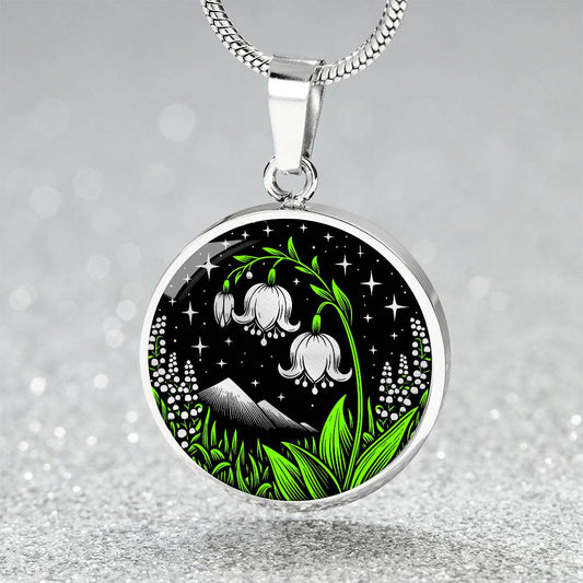 An Elegant silver pendant Lily Of The Valley Necklace featuring Green Grass, Silver Mountains, Stars,  Lily Of The Valleys with a black backdrop. This jewelry offers personalization with an engraving option for a name.