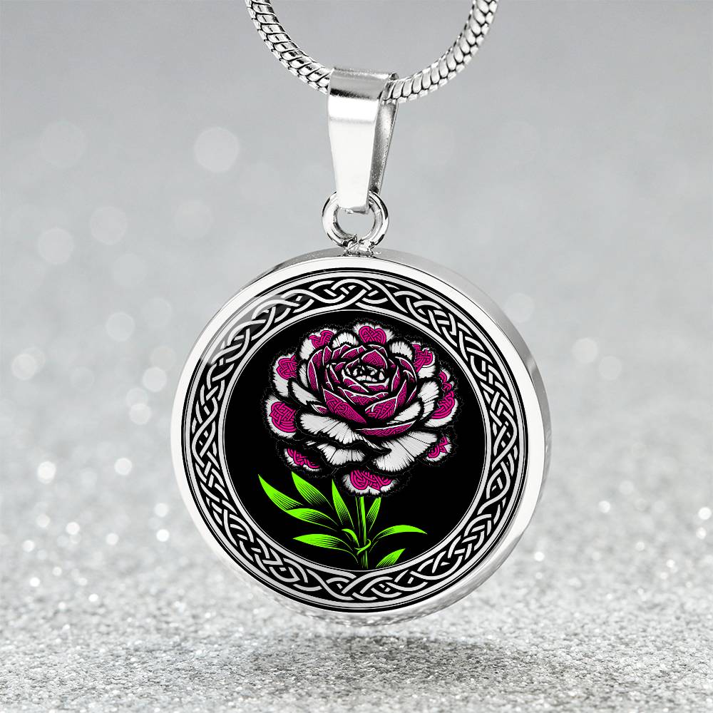 an Elegant January silver pendant Celtic Carnation Birth Flower necklace featuring a vivid pink, green and silver flower, set against a black backdrop. This jewelry offers personalization with an engraving option for a name.