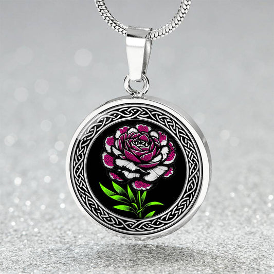 an Elegant January silver pendant Celtic Carnation Birth Flower necklace featuring a vivid pink, green and silver flower, set against a black backdrop. This jewelry offers personalization with an engraving option for a name.