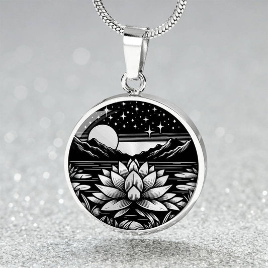 An Elegant silver pendant Water Lily Necklace featuring Mountains, Stars, Moon, Lily Pads, Water lilies all in black and silver. This jewelry offers personalization with an engraving option for a name.