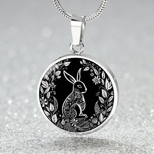 Elegant silver pendant Easter Bunny necklace featuring Silver bunny with leaves and flowers all in silver with a black background. This jewelry offers personalization with an engraving option for a name.