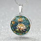 an elegant silver pendant Water Lily Necklace. The colors are Green Leaves, Blue Water and Tan Flowers. This jewelry offers personalization with an engraving option for a name.