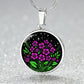 an Elegant silver pendant featuring a vivid Purple African Violet Birth Flower Necklace with green grass, silver stars set against a Black backdrop. This jewelry offers personalization with an engraving option for a name.