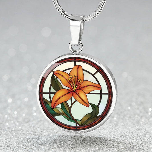 Elegant Silver pendant necklaces features an Orange Tiger Lily, Green Grass, white background with a red and brown frame. This necklace offers personalization with an engraving option for a name.