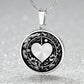 An Elegant silver pendant featuring a Valentines Design with a vivid Silver Moonlight Heart Necklace, set against a silver and black backdrop with a sword and flowers. This jewelry offers personalization with an engraving option for a name.