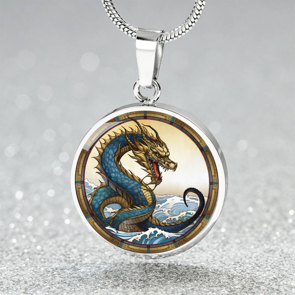 An Elegant silver pendant featuring a Water Dragon Necklace. Blue and yellow Dragon with a blue ocean, tan border and backdrop. This jewelry offers personalization with an engraving option for a name.