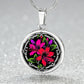Elegant silver pendant featuring a vivid red, Pink & Purple honeysuckles, Junes birth month flower, set against a black backdrop with the metal shinning through. This necklace offers personalization with an engraving option for a name.