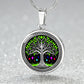 an Elegant silver pendant Tree of Life necklace featuring a vivid Celtic Green and silver tree, set against a black backdrop with red,blue,purple,orange gems. This jewelry offers personalization with an engraving option for a name.