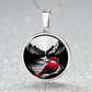 An elegant silver pendant Red Cardinal Necklace. The colors are silver, red and black. This jewelry offers personalization with an engraving option for a name.