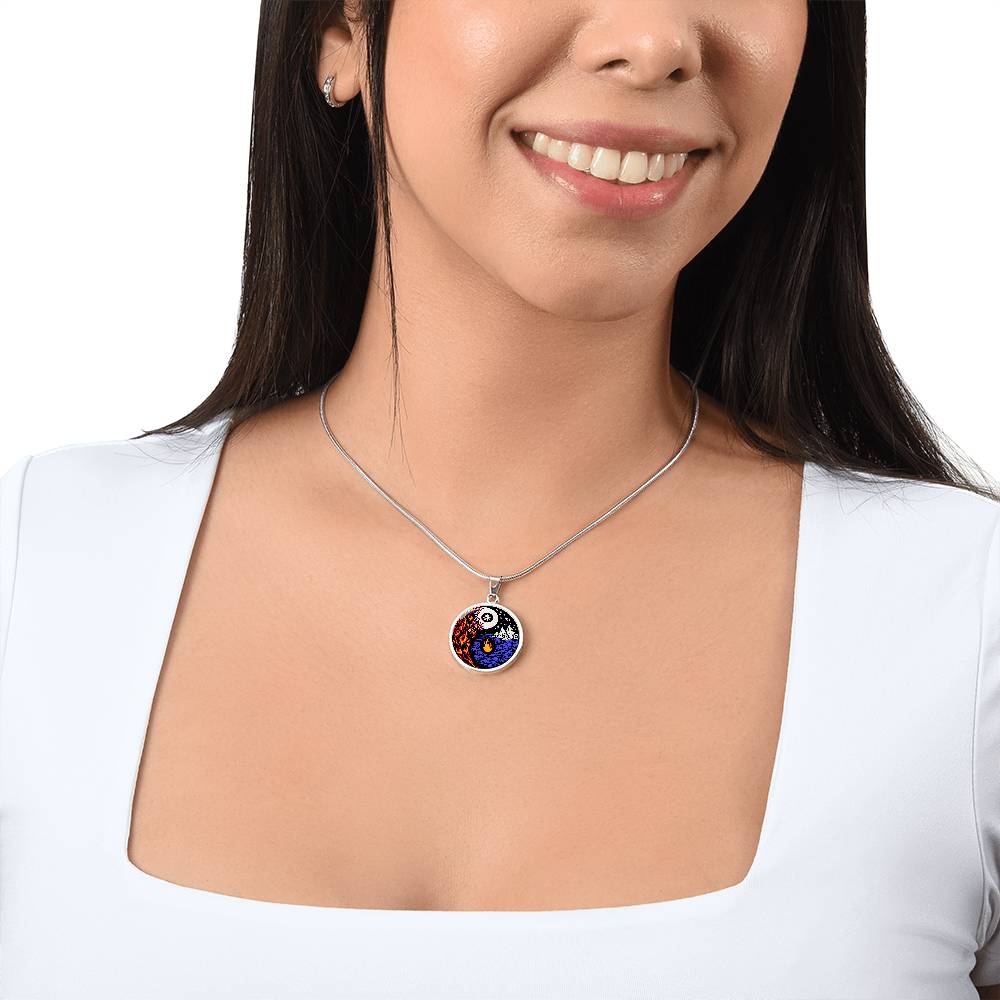 Woman wearing an Elegant silver pendant featuring a vivid Red/Orange Fire, Blue Water, Silver snow flakes and Silver Icebergs. set against a silver & Black backdrop. This jewelry offers personalization with an engraving option for a name.