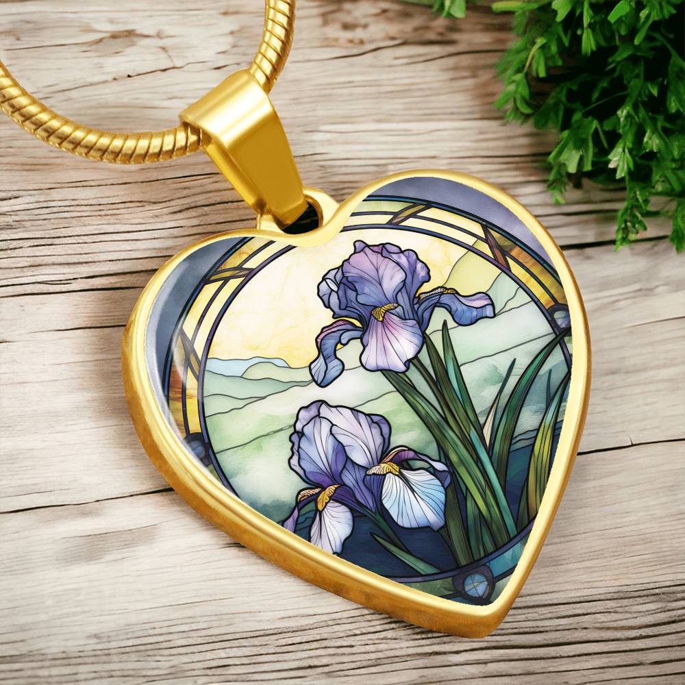 Gold Heart Pendant Purple Iris flower necklace, With green grass, a Yellow sunset and Green mountains. This necklace offers personalization option for a name.