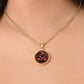 Woman wearing An Elegant gold pendant featuring a Year of the Snake and Year of The Dragon Necklace in red, yellow, gold and black. This jewelry offers personalization with an engraving option for a name.
