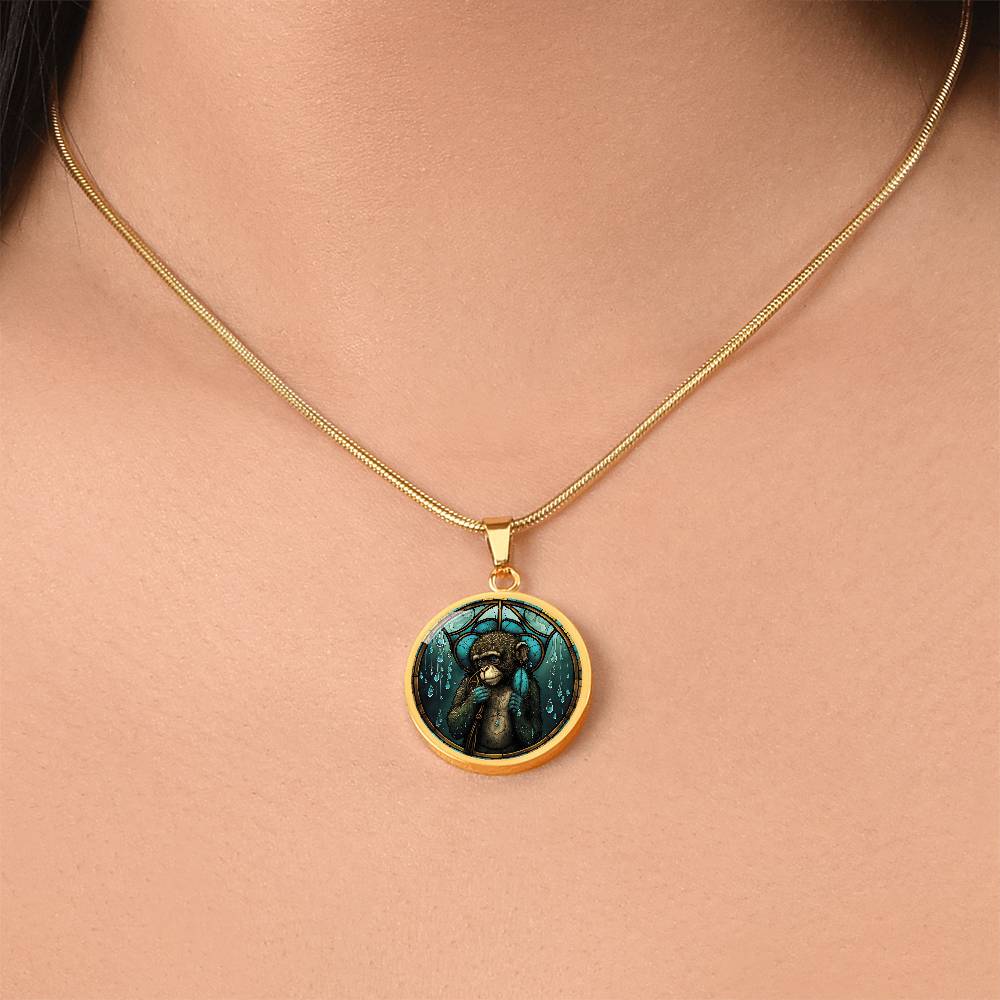 Woman wearing an elegant gold pendant Chinese Zodiac Monkey Necklace. The colors are yellow, blue, teal, brown and green. This jewelry offers personalization with an engraving option for a name.