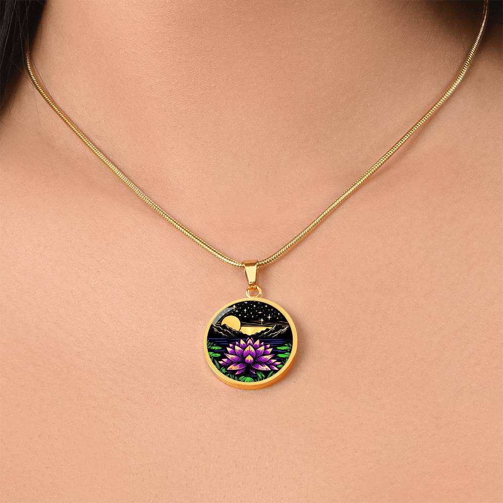 Woman wearing An Elegant gold pendant Water Lily Necklace featuring Mountains, Stars, Yellow outline Sun, Green grass Lily Pads, Blue Water, Pink lily, black and gold Background. This jewelry offers personalization engraving option for a name.