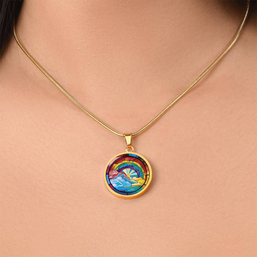 Woman wearing an elegant gold pendant Lucky Rainbow Necklace. The colors are all the colors of the rainbow. This jewelry offers personalization with an engraving option for a name.