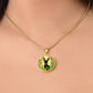 Woman wearing An Elegant gold pendant Deer Necklace. All in gold and black with green leaves. This jewelry offers personalization with an engraving option for a name.