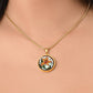 Woman wearing an Elegant Gold pendant necklaces features an Orange Tiger Lily, Green Grass, white background with a red and brown frame. This necklace offers personalization with an engraving option for a name.