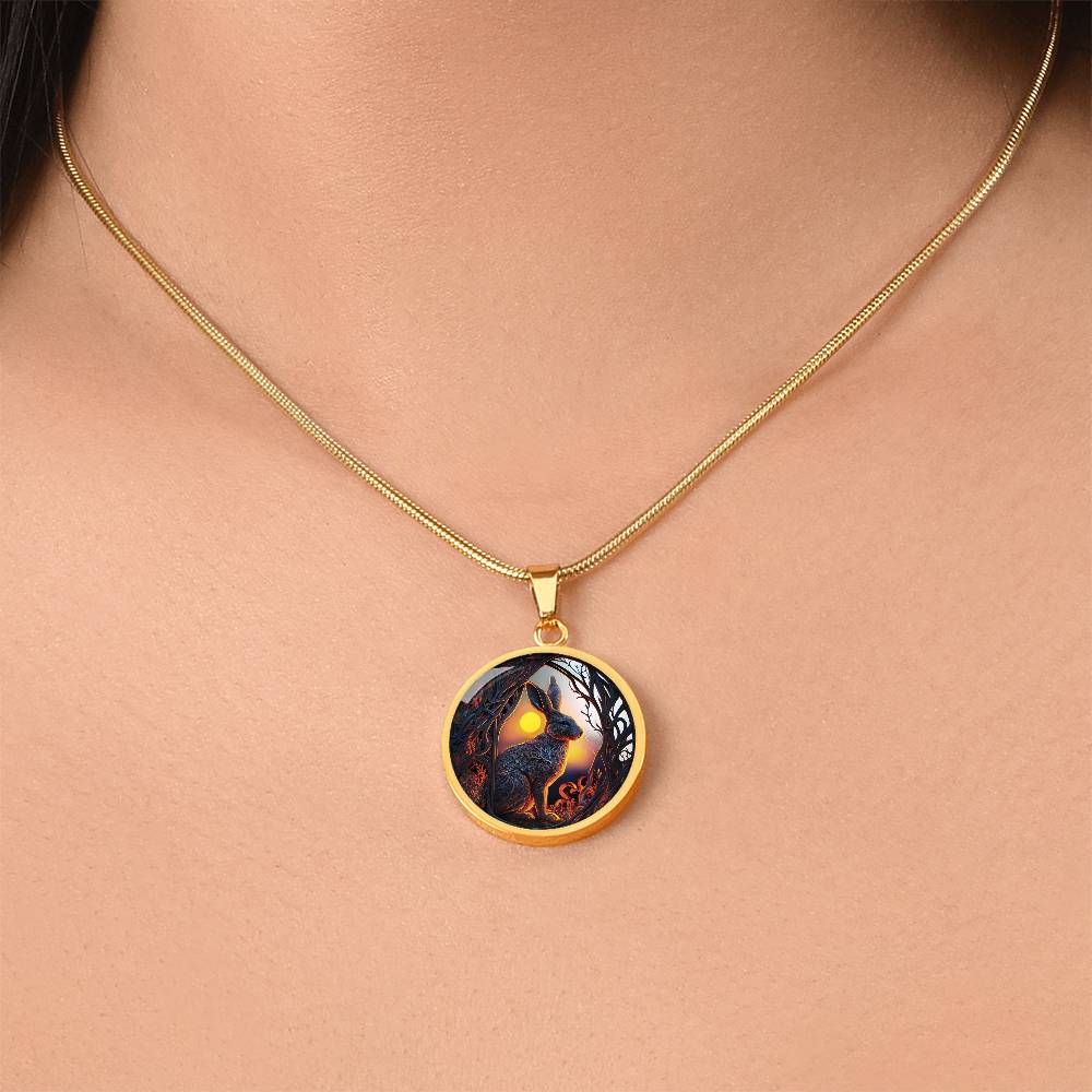 Woman wearing an Elegant gold pendant Easter Bunny necklace featuring yellow sun, brown trees, brown rabbit, blue and white sky. This jewelry offers personalization with an engraving option for a name.