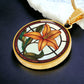 An Elegant Gold pendant necklaces features an Orange Tiger Lily, Green Grass, white background with a red and brown frame. This necklace offers personalization with an engraving option for a name.