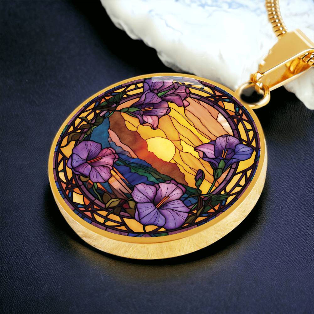 an elegant gold pendant Morning Glory Necklace. The colors are purple flowers, blue/green/purple hills, Brown mountains, Yellow sun and sky. This jewelry offers personalization with an engraving option for a name.