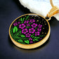 an Elegant gold pendant featuring a vivid Purple African Violet Birth Flower Necklace with green grass, gold stars set against a Black backdrop. This jewelry offers personalization with an engraving option for a name.