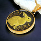 An Elegant gold pendant Rabbit Necklace. Yellow Rabbit and Flowers with a black and brown backdrop. This jewelry offers personalization with an engraving option for a name.