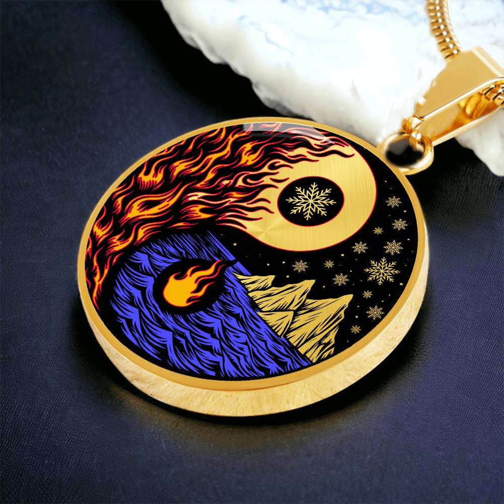 an Elegant gold pendant featuring a vivid Red/Orange Fire, Blue Water, gold snow flakes and gold Icebergs. set against a gold & Black backdrop. This jewelry offers personalization with an engraving option for a name.