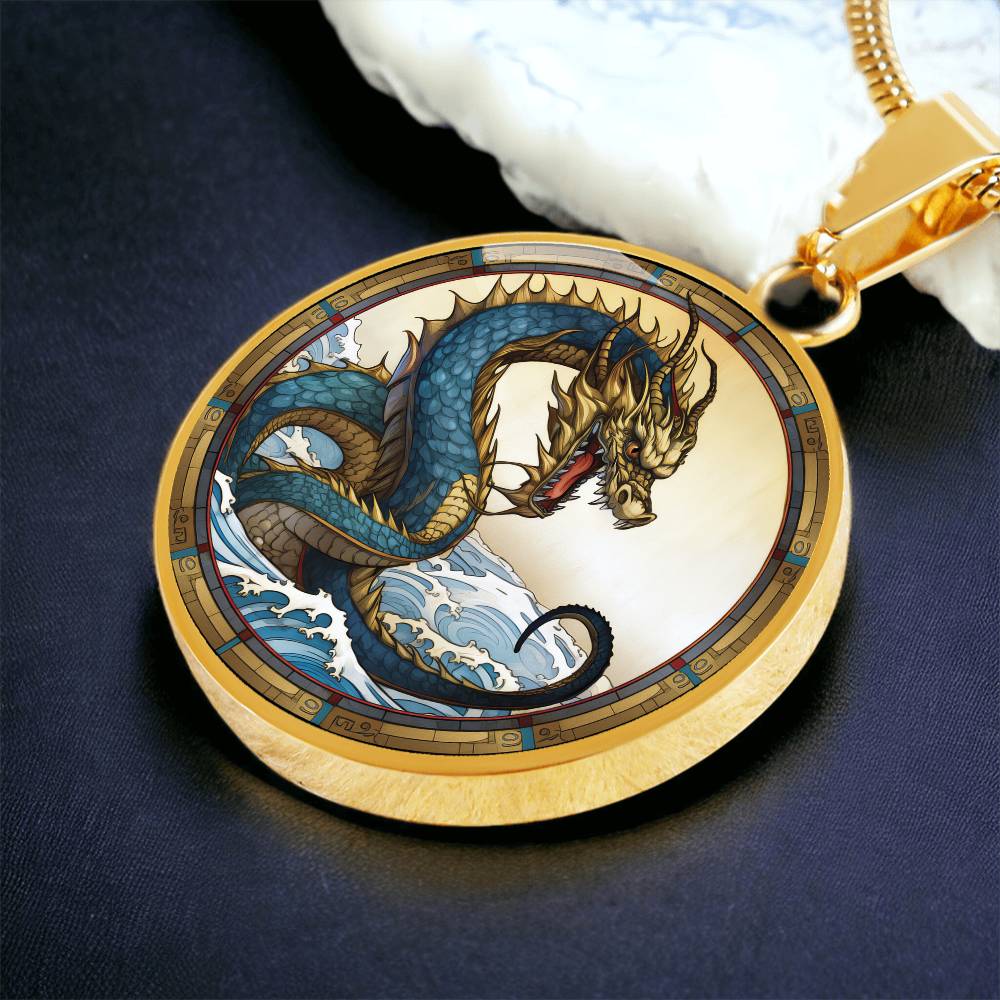 An Elegant gold pendant featuring a Water Dragon Necklace. Blue and yellow Dragon with a blue ocean, tan border and backdrop. This jewelry offers personalization with an engraving option for a name.