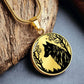 an Elegant gold pendant wolf necklace featuring a vivid Black Wolf in the forest, set against a Gold backdrop. This jewelry offers personalization with an engraving option for a name.