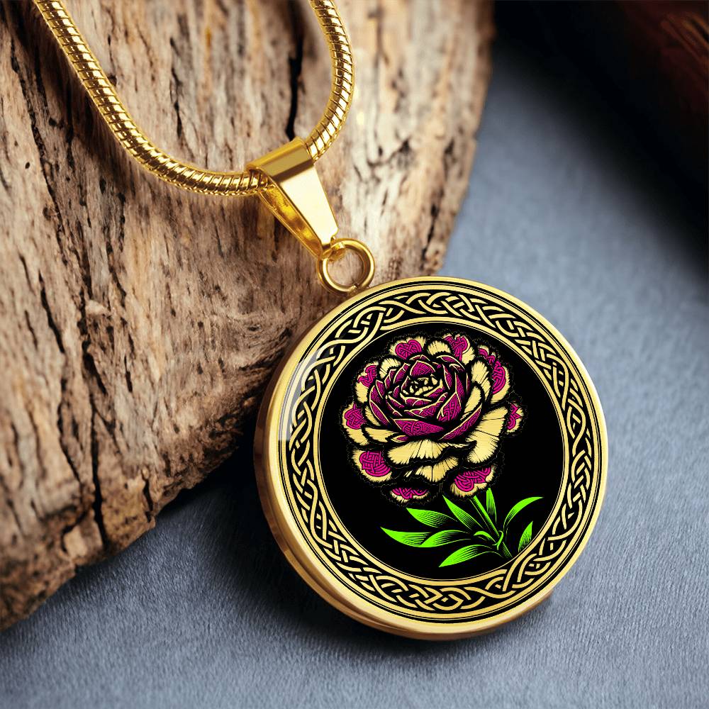 Elegant January gold pendant Celtic Carnation Birth Flower necklace featuring a vivid pink, green and gold flower, set against a black backdrop. This jewelry offers personalization with an engraving option for a name.