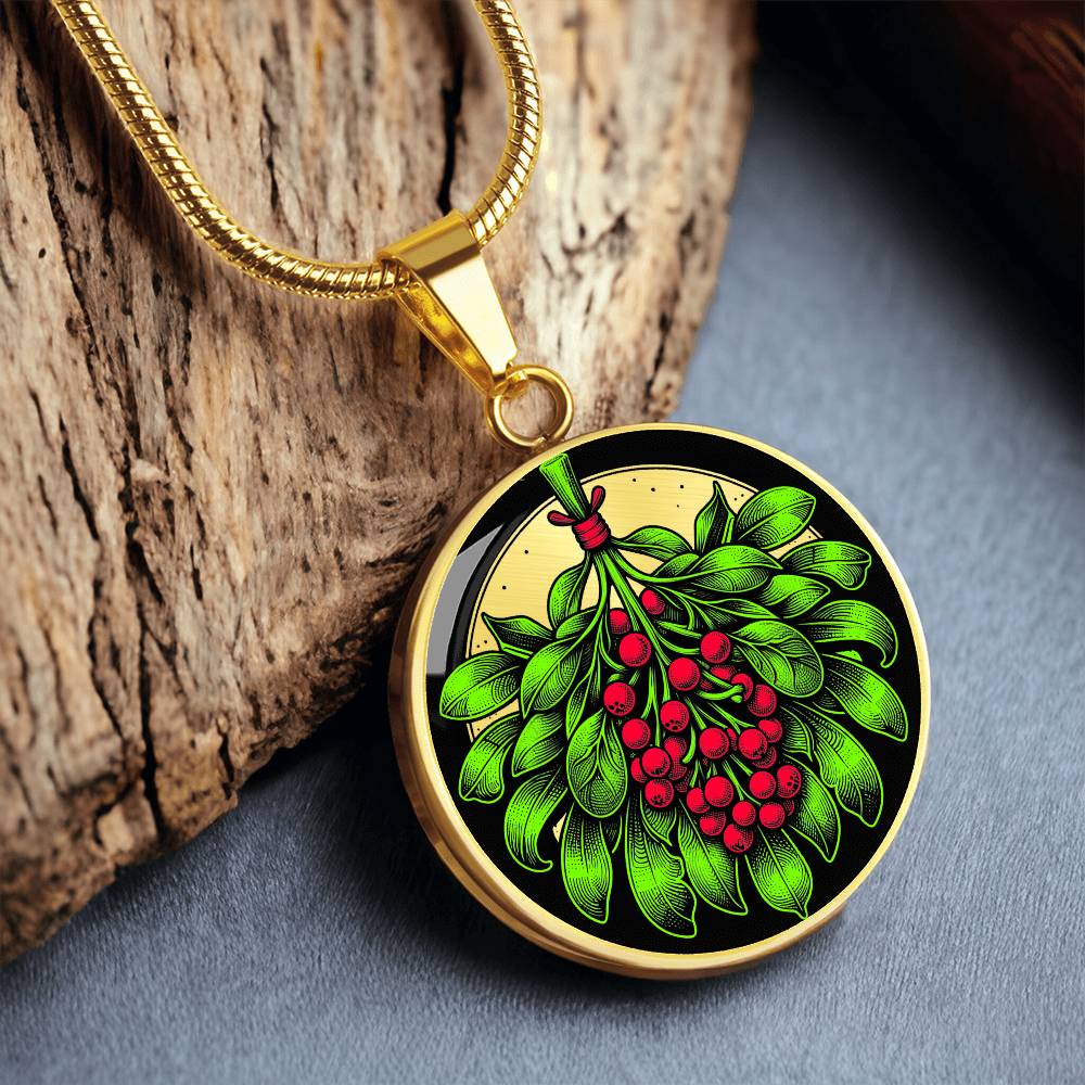 Elegant gold pendant necklace featuring a vivid Mistletoe with red berries set against a gold & black backdrop. This necklace offers personalization with an engraving option for a name.