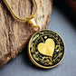 An Elegant gold pendant featuring a Valentines Design with a vivid gold Moonlight Heart Necklace, set against a gold/black backdrop with a sword and flowers. This jewelry offers personalization with an engraving option for a name.