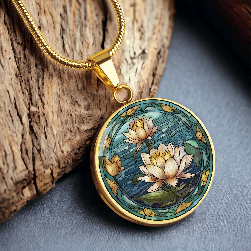 an elegant gold pendant Water Lily Necklace. The colors are Green Leaves, Blue Water and Tan Flowers. This jewelry offers personalization with an engraving option for a name.