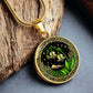 An Elegant gold pendant Celtic Lily Of The Valley Necklace featuring Green Grass, gold Mountains, Stars,  Lily Of The Valleys, Celtic Knot Frame with a black backdrop. This jewelry offers personalized engraving option for a name.