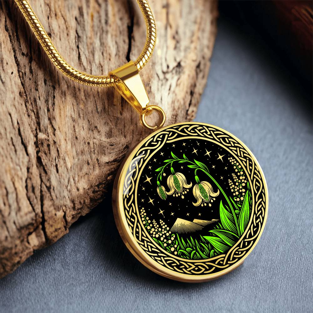 An Elegant gold pendant Celtic Lily Of The Valley Necklace featuring Green Grass, gold Mountains, Stars,  Lily Of The Valleys, Celtic Knot Frame with a black backdrop. This jewelry offers personalized engraving option for a name.