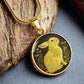 An Elegant gold pendant Rabbit Necklace. Yellow Rabbit and Flowers with a black and brown backdrop. This jewelry offers personalization with an engraving option for a name.
