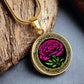 an Elegant January gold pendant Celtic Carnation Birth Flower necklace featuring a vivid pink, green flower, set against a gold & black backdrop. This jewelry offers personalization with an engraving option for a name.