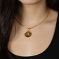 Woman wearing an Elegant gold pendant Year of the Rabbit and Year of the Dragon Necklace. The colors are yellow, Red and Black . This jewelry offers personalization with an engraving option for a name.