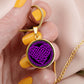Woman holding an Elegant gold pendant featuring a vivid purple Heart Celtic Necklace set against a Black & Gold backdrop. This jewelry offers personalization with an engraving option for a name.