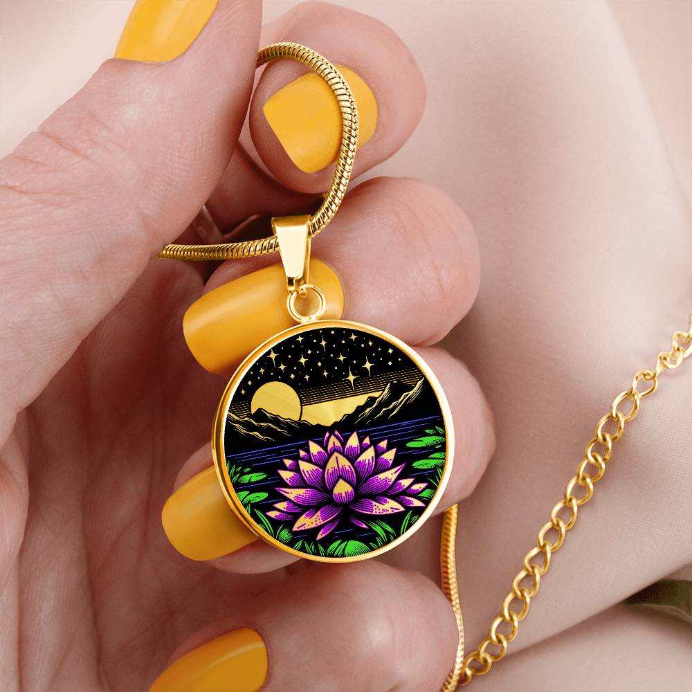 Woman holding An Elegant gold pendant Water Lily Necklace featuring Mountains, Stars, Yellow outline Sun, Green grass Lily Pads, Blue Water, Pink lily, black and gold Background. This jewelry offers personalization engraving option for a name.