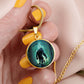 Woman holding an Elegant gold pendant Bigfoot Necklace. Colors are Green, Brown, Black, Blue and White. This jewelry offers personalization with an engraving option for a name.