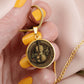 Woman holding an elegant gold pendant Violet Necklace. The colors are brown, black and tan. This jewelry offers personalization with an engraving option for a name.