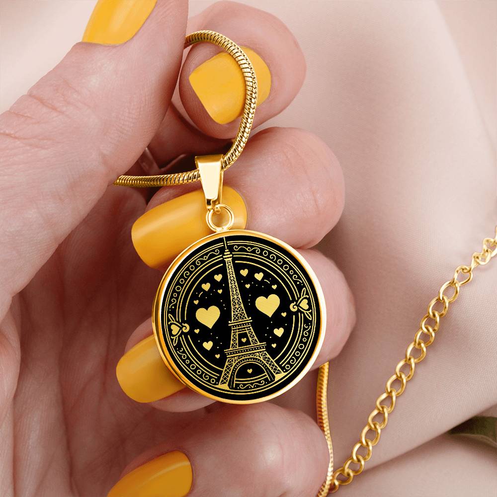 Woman holding An Elegant gold pendant featuring a Valentines Design with a vivid Gold Eiffel Tower Necklace, set against a gold and black backdrop. This jewelry offers personalization with an engraving option for a name.