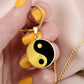 Woman holding a Gold Pendant Yin Yang Necklace